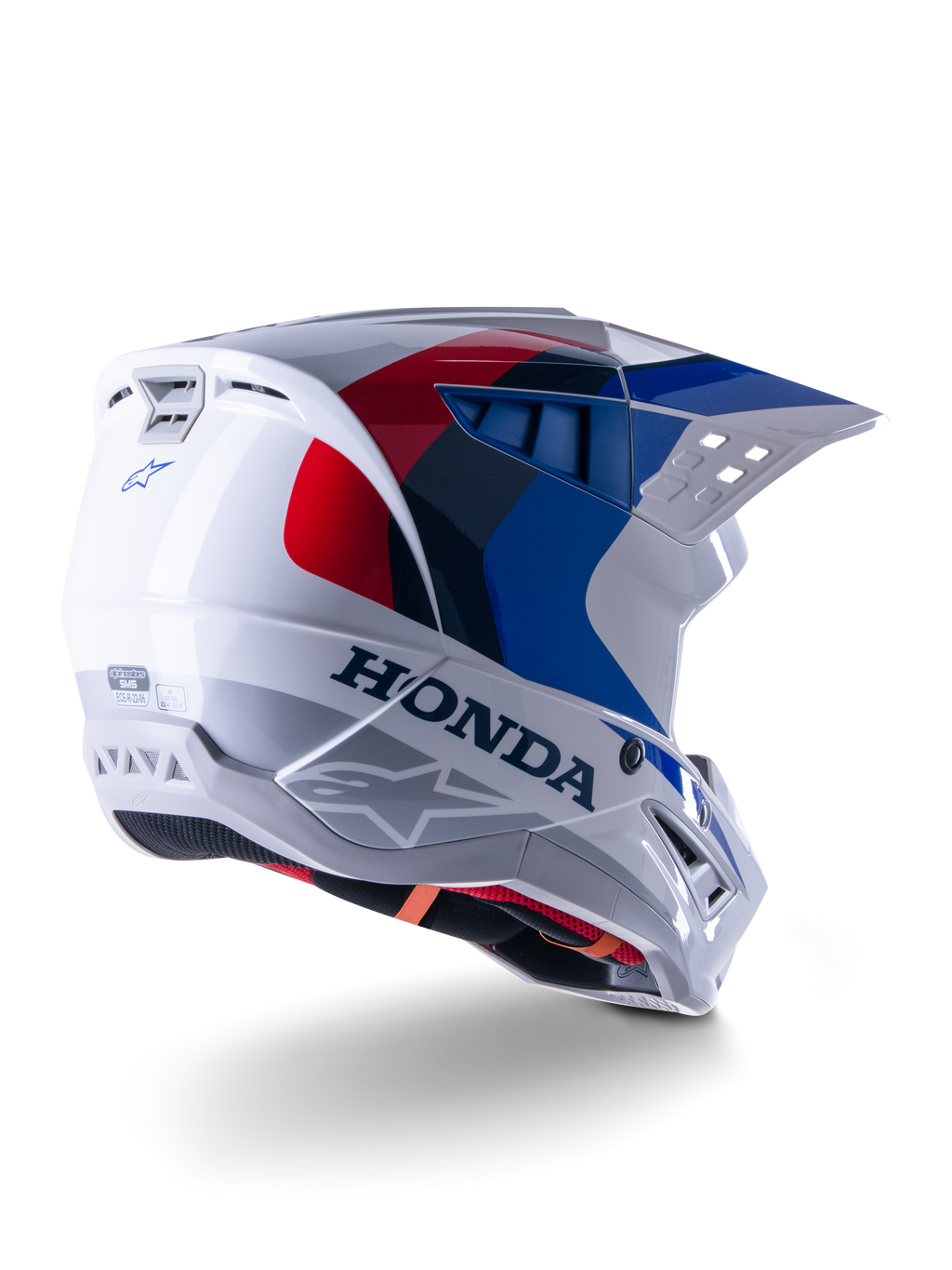 Alpinestars Honda S-M5 Helmet ECE, kask motocrossowy, biało-niebiesko-czerwony z połyskiem, z wyraźnym brandingiem Honda i logo Alpinestars, aerodynamiczna skorupa ze zintegrowanymi otworami wentylacyjnymi i regulowanym daszkiem, sprzęt ochronny do wyścigów off-road