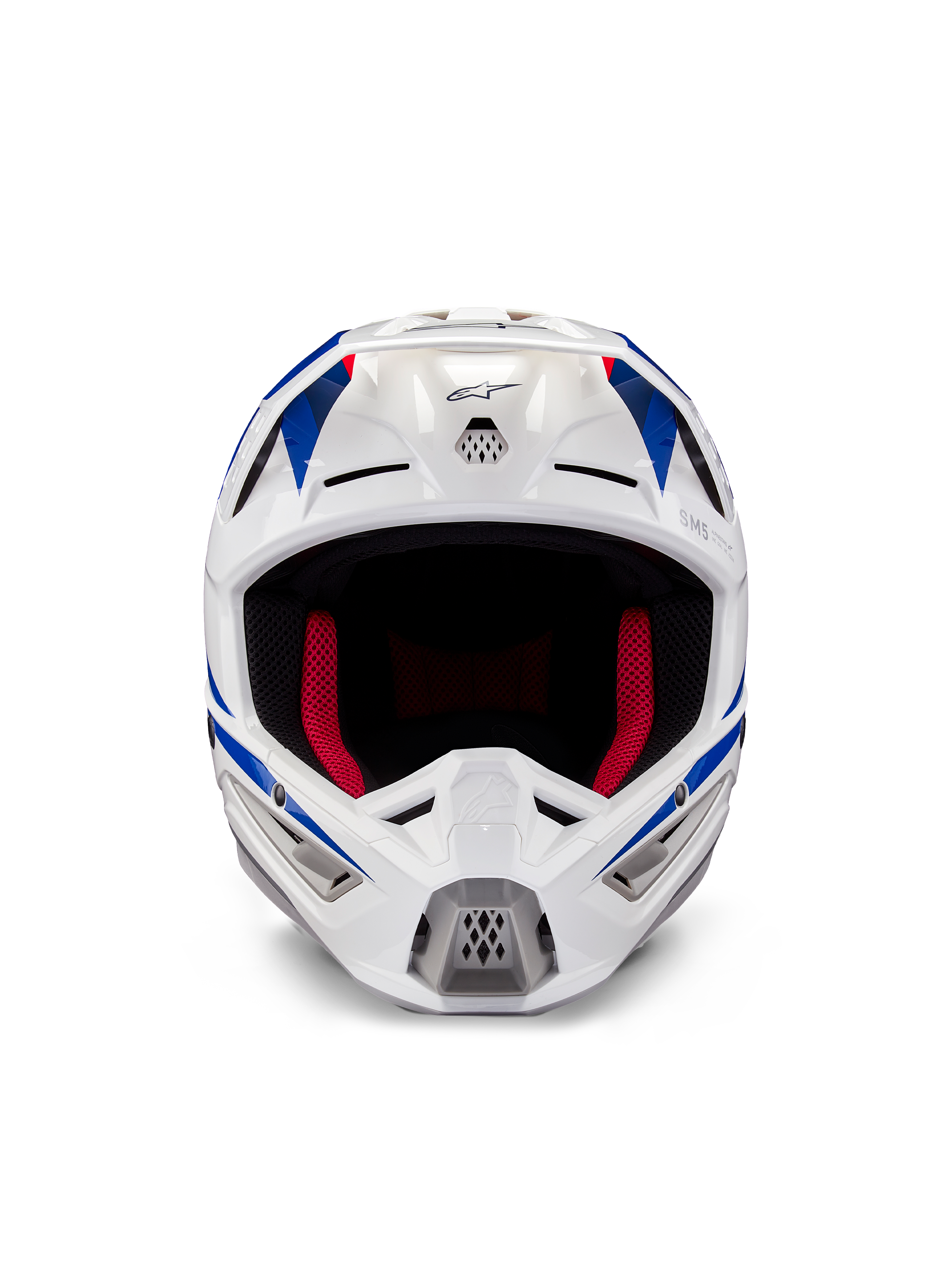Kask Alpinestars Honda S-M5 ECE, kask motocrossowy, biało-niebiesko-czerwony z połyskiem, widok z przodu ukazujący otwory wentylacyjne i czerwoną wyściółkę wewnętrzną, aerodynamiczna konstrukcja zapewniająca ochronę w wyścigach terenowych
