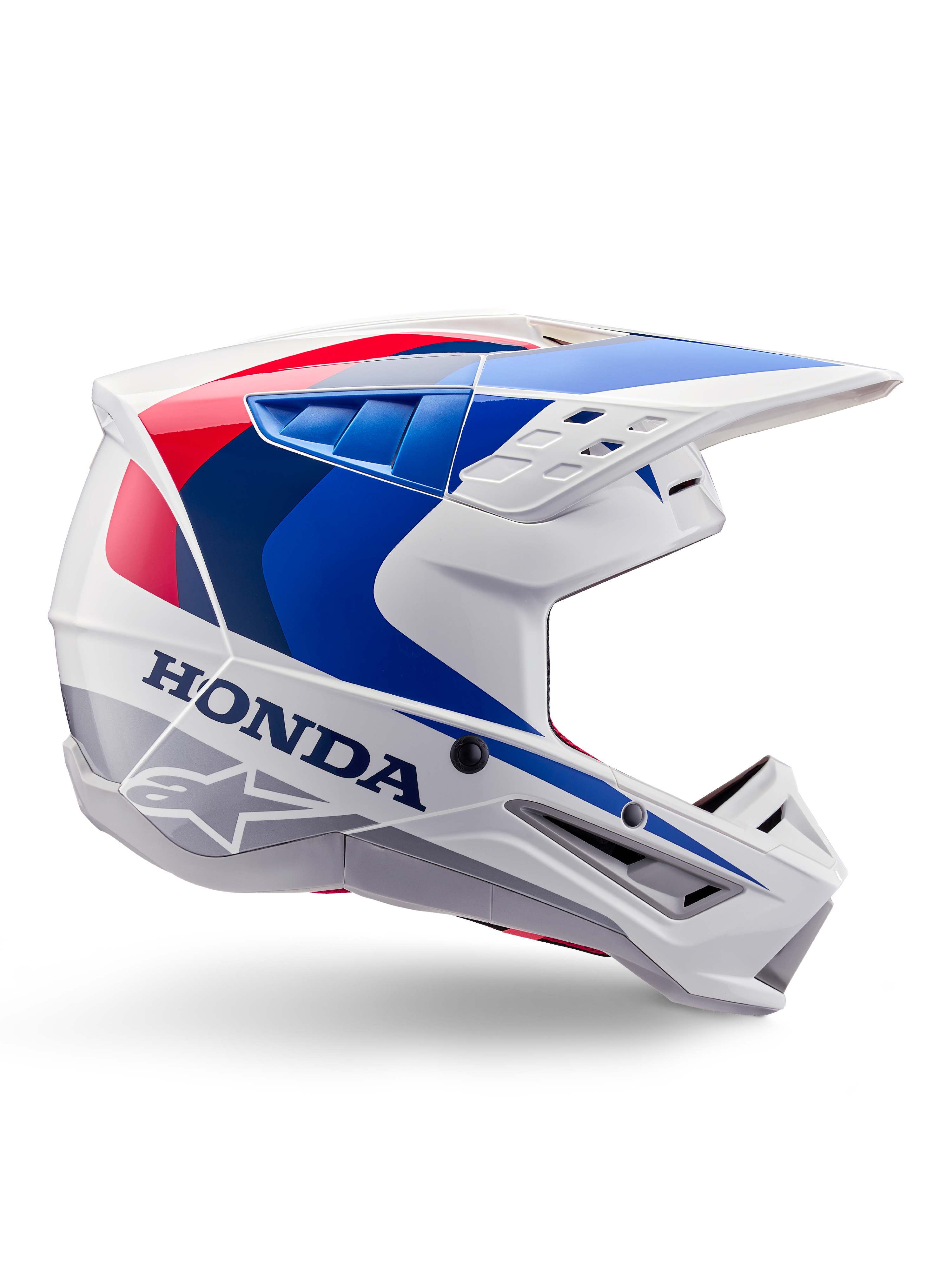 Kask Alpinestars Honda S-M5 Helmet ECE, kask motocrossowy, biały, niebieski i czerwony, widok z profilu, aerodynamiczny design ze zintegrowanym daszkiem, liczne otwory wentylacyjne, błyszczące wykończenie, wyraźne logo Honda i Alpinestars