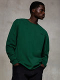 Alpinestars Essentials Ageless LS Tee, koszulka z długim rękawem, ciemnozielona (Pine Green), małe czarne logo na piersi, okrągły dekolt, luźny krój, wysokiej jakości bawełna organiczna, codzienna odzież typu streetwear