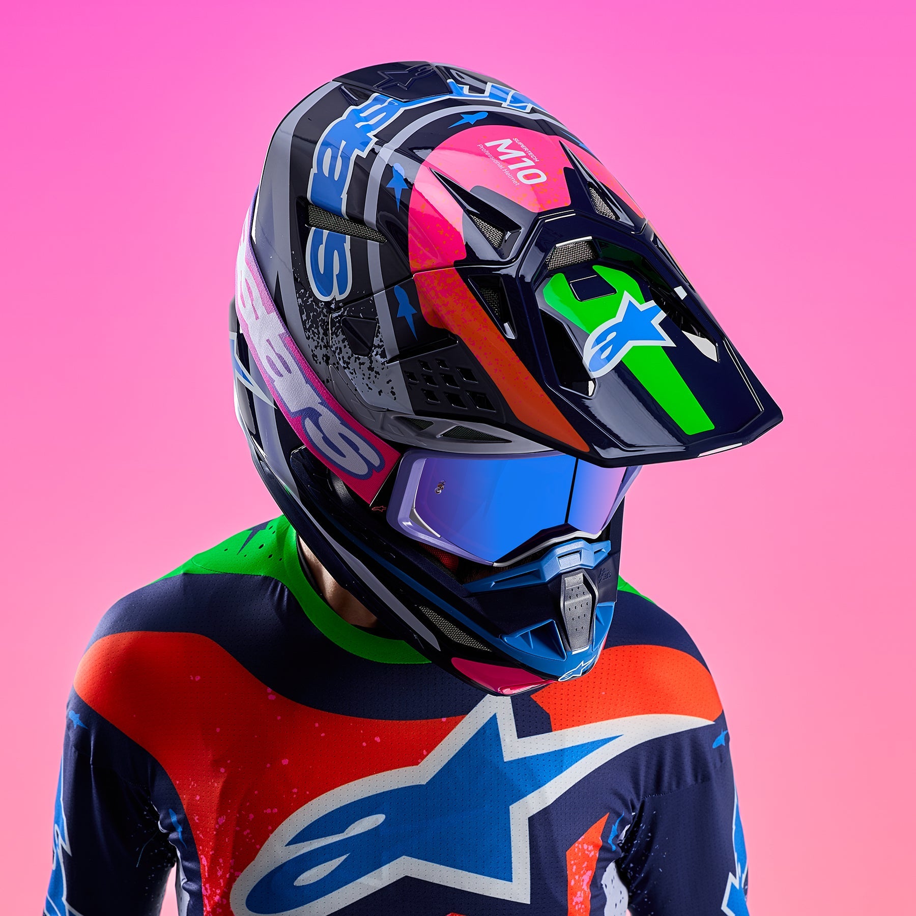 Alpinestars Limited Edition Supertech M10 Records Helmet, multicolor motocross helmet with blue goggles worn by rider.