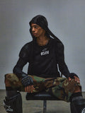 RSRV Nucleon SS Tee, Black T-shirt with white RSRV logo, worn with black hoodie, camouflage pants, fingerless gloves, and knee pads, urban tactical style, Alpinestars lifestyle collection