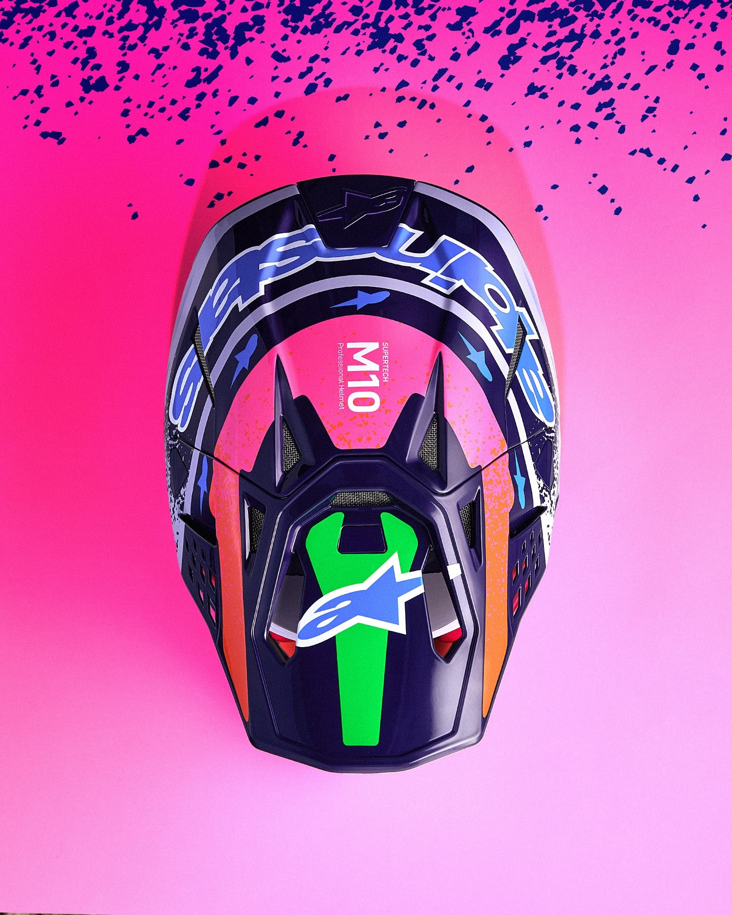 Alpinestars Limited Edition Supertech M10 Records Helmet, carbon-kevlar motocross gear in dark blue and pink with neon accents.