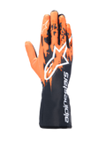 Rękawice Alpinestars Tech-1 K V3, rękawice kartingowe, czarno-pomarańczowo-białe, z sublimowaną grafiką z pomarańczowymi pociągnięciami pędzla na czarnym tle, duże białe logo Astar na wierzchu dłoni, pionowy napis Alpinestars na mankiecie, profesjonalny sprzęt do kartingu