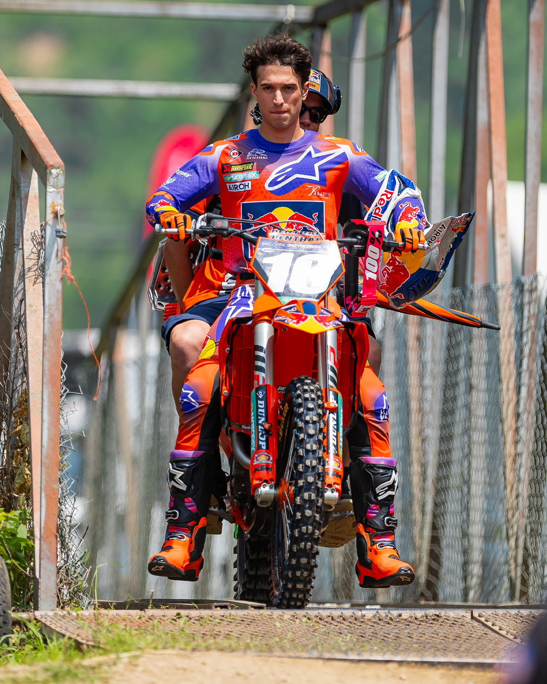 Tom Vialle in colorful Alpinestars motocross gear on a dirt bike, with a blurred background