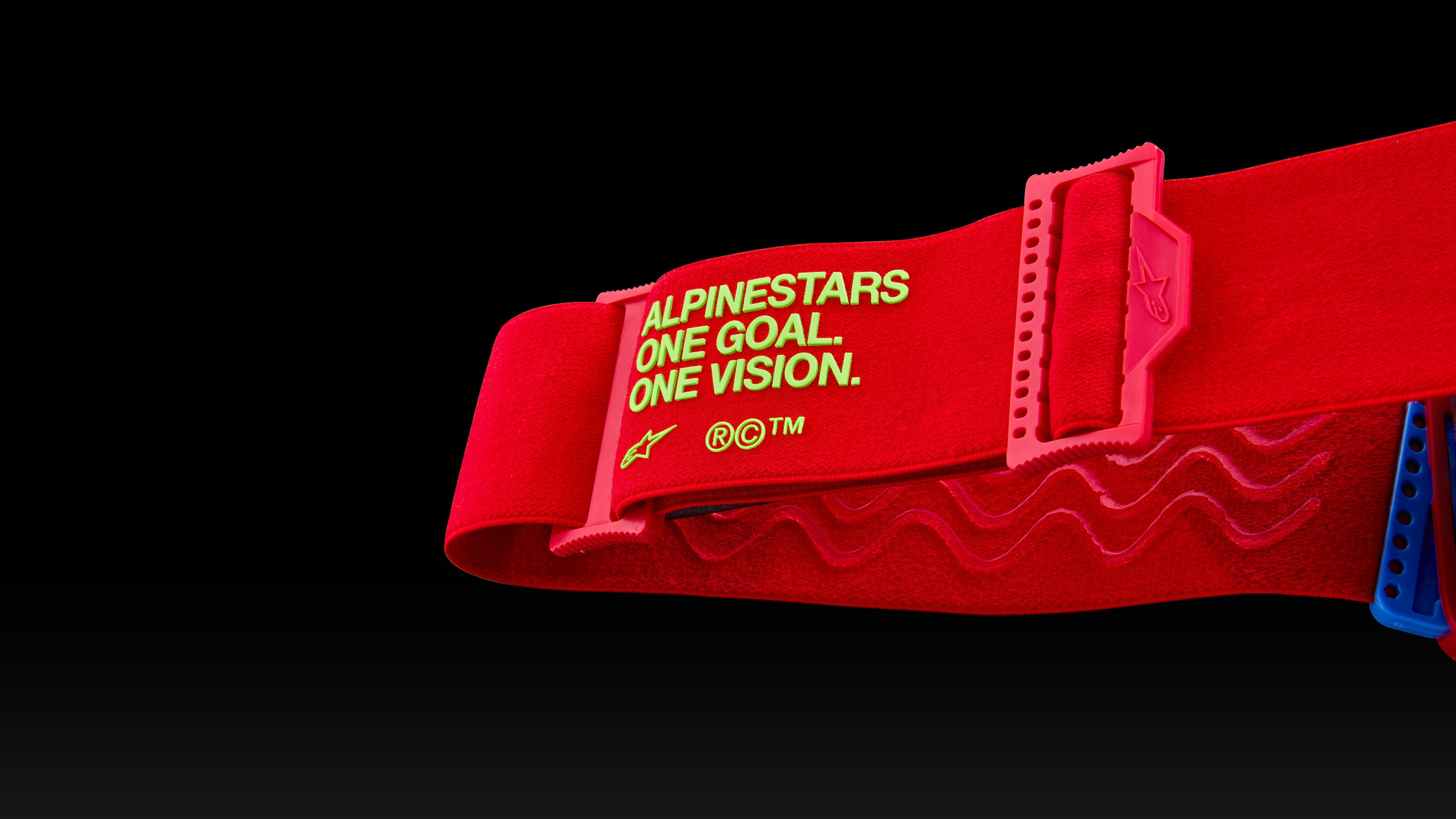 Alpinestars red motocross goggle strap with neon green One Goal. One Vision. branding and adjustable buckle for off-road.