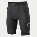 Alpinestars Youth Paragon Lite Protection Short, rowerowe spodenki ochronne, czarne, oddychająca siateczka, zintegrowane ochraniacze bioder, białe logo Alpinestars na pasie i boku nogawki, lekkie ochronne spodenki wewnętrzne do MTB